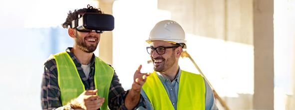 Workers on site with VR headset and safety helmet